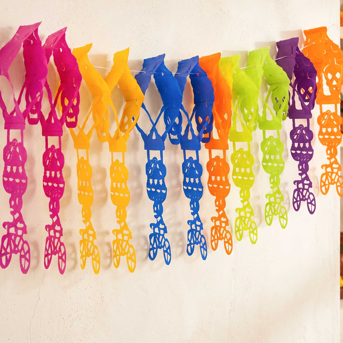 Colorful Calaca on a Bike Papel Picado Banner
